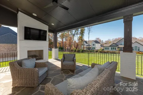 a outdoor living space with patio furniture and a fireplace