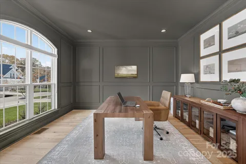 a view of a dining room with furniture a rug and windows