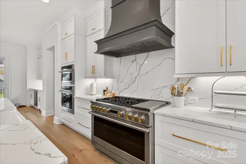 a kitchen with stainless steel appliances granite countertop a stove and a sink