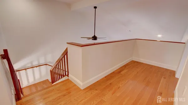 a view of a room with wooden floor