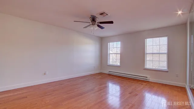 wooden floor in an empty room with a window