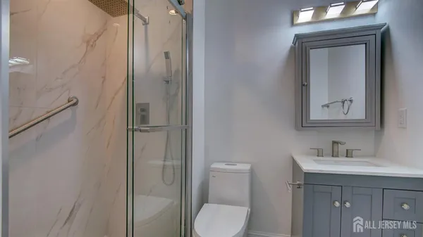 a bathroom with a toilet sink shower and mirror