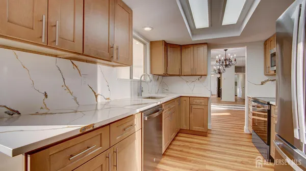 a kitchen with granite countertop cabinets and steel stainless steel appliances