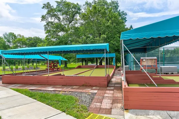 a view of backyard with swimming pool and seating space
