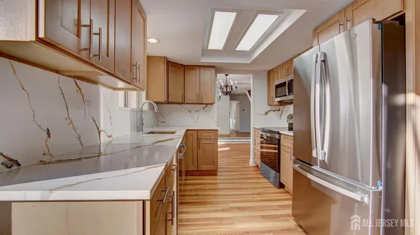 a kitchen with a refrigerator and a sink