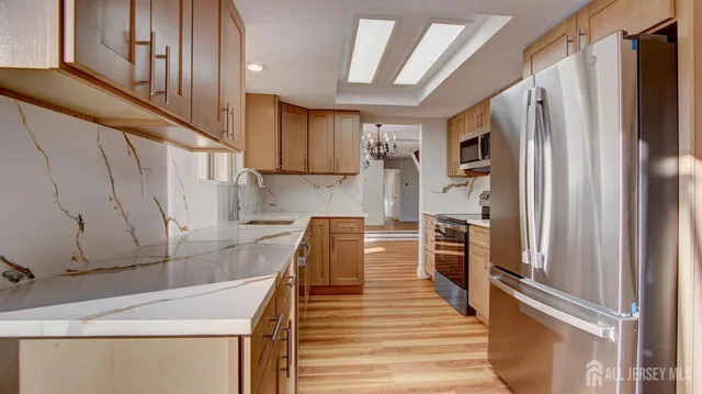 a kitchen with a refrigerator and a sink