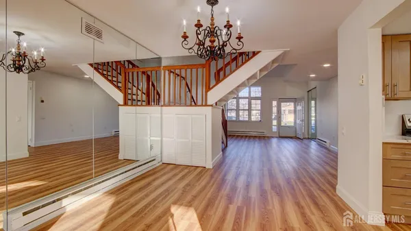 a view of entryway and hall with wooden floor