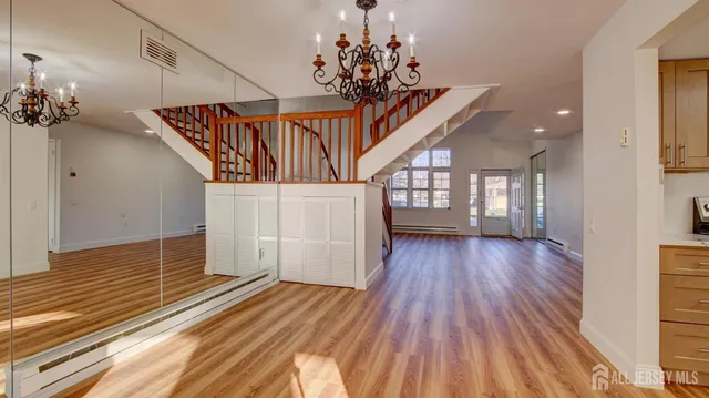 a view of entryway and hall with wooden floor