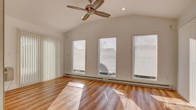 a view of room with window and hardwood floor