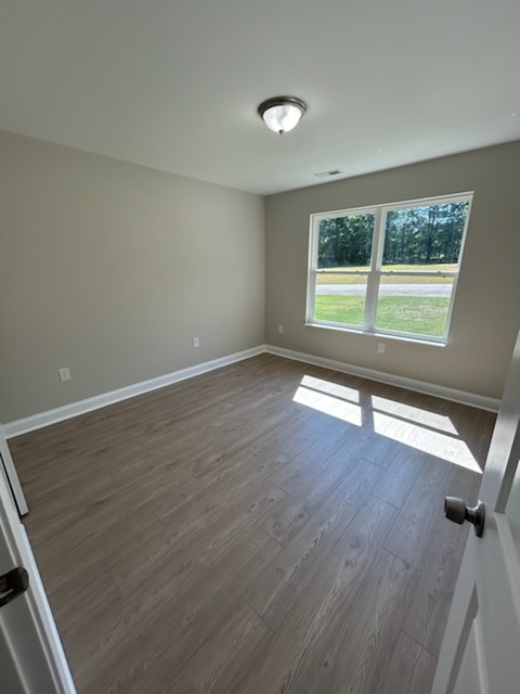 708 Hampton Street Iva, SC 29655 - Photo 10 of 14 This bright room features beautiful flooring and abundant natural light through a large window.