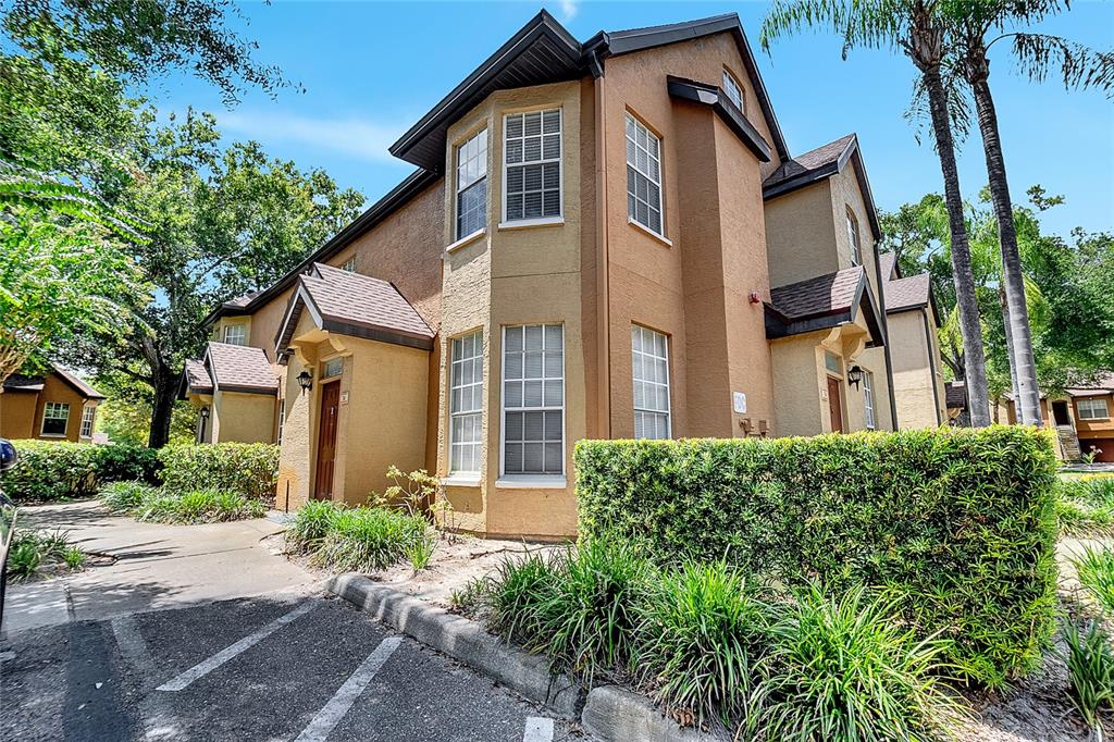 6324 Raleigh Street, Unit 711 Orlando, FL 32835 - Photo 1 of 1 a front view of a house with a yard