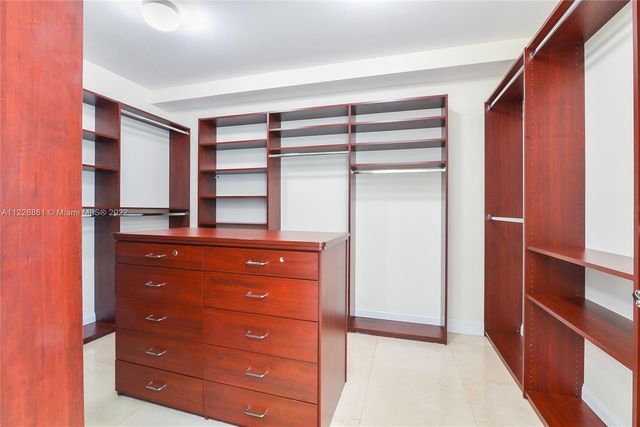 a room with a dresser and a wooden cabinets