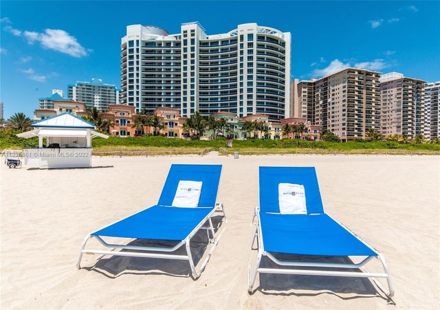 a view of swimming pool with outdoor seating and city view