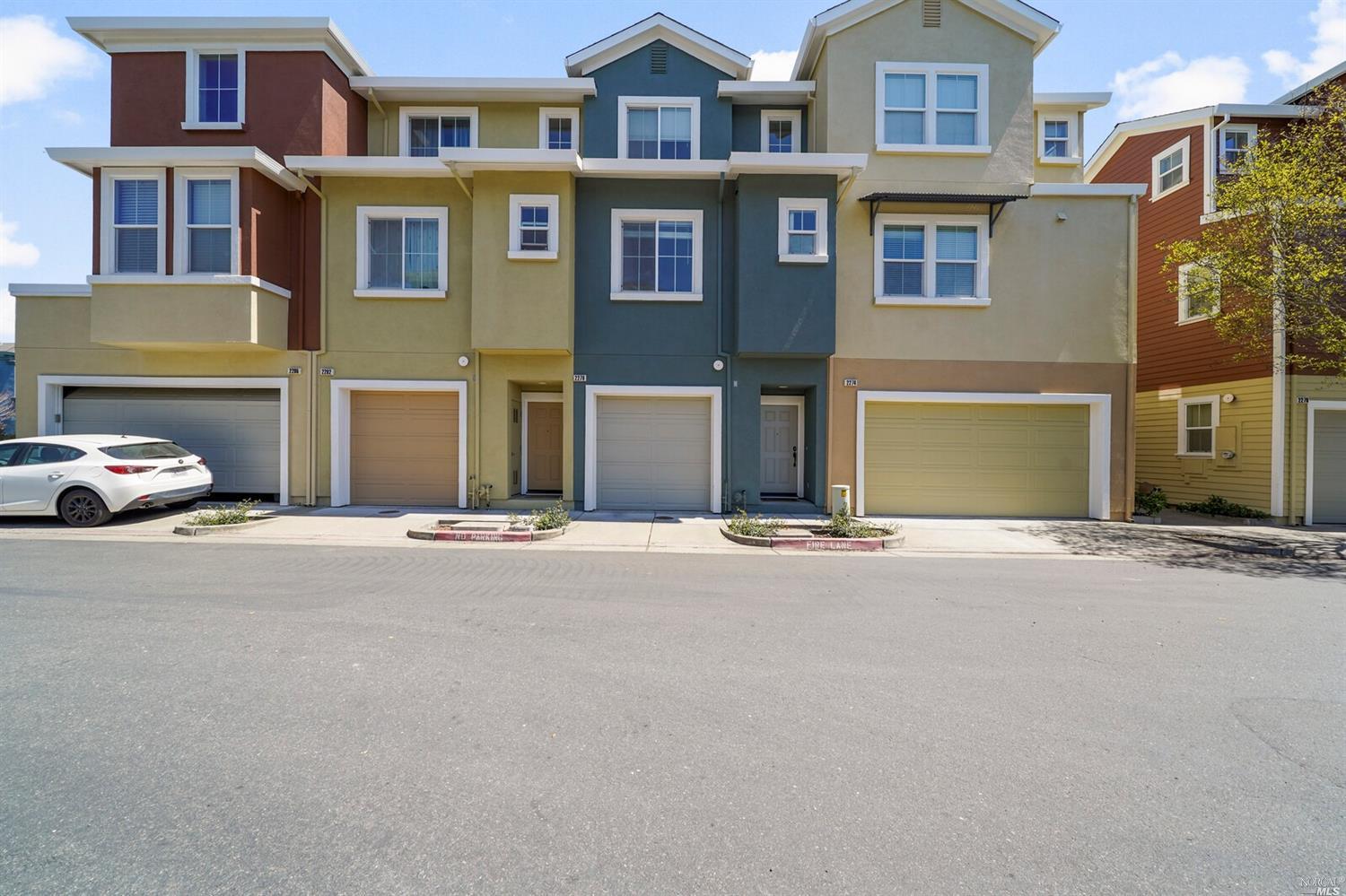 a couple of cars parked in front of a building