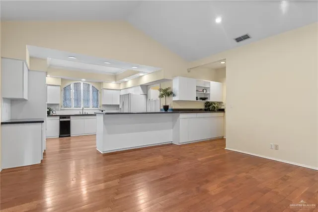 a kitchen with stainless steel appliances a refrigerator and a sink
