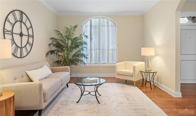 a living room with furniture a table and a potted plant
