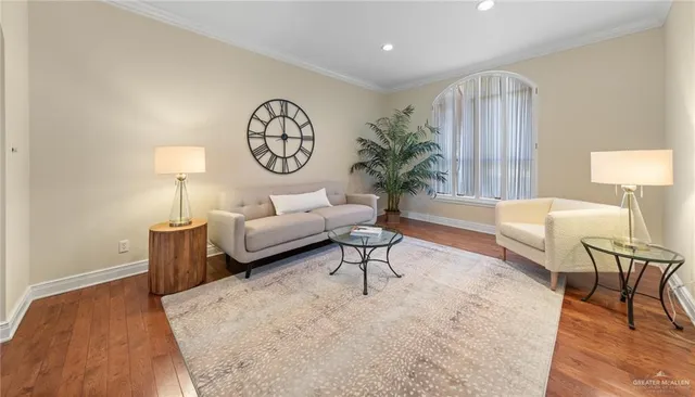 a living room with furniture a clock and a window