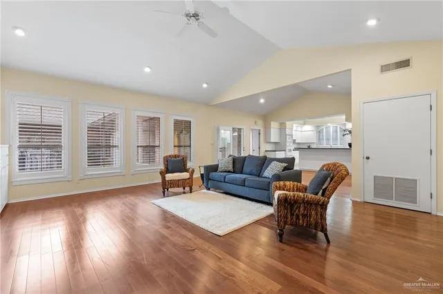 a living room with furniture and a wooden floor