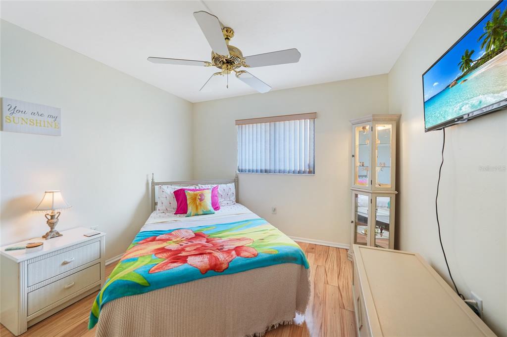 25225 Rampart Boulevard, Unit 1604 Punta Gorda, FL 33983 - Photo 13 of 39 a bedroom with a bed and a chandelier