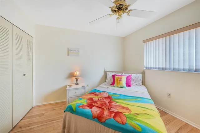 a bedroom with a bed and a wooden floor