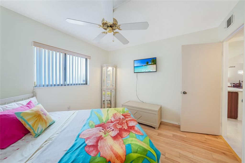 25225 Rampart Boulevard, Unit 1604 Punta Gorda, FL 33983 - Photo 15 of 39 a bedroom with a bed and a wooden floor