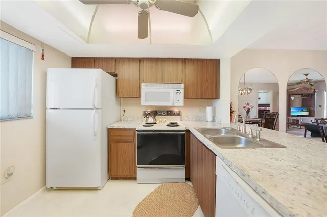 a kitchen with a sink a stove and cabinets