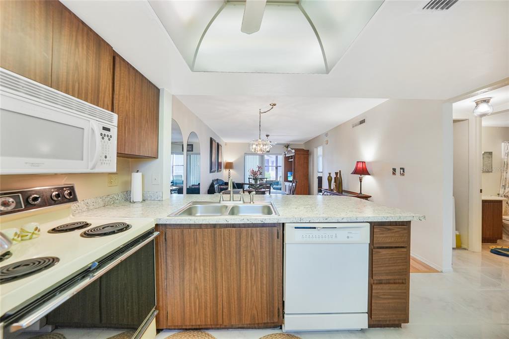 25225 Rampart Boulevard, Unit 1604 Punta Gorda, FL 33983 - Photo 18 of 39 a kitchen with a sink a stove and cabinets