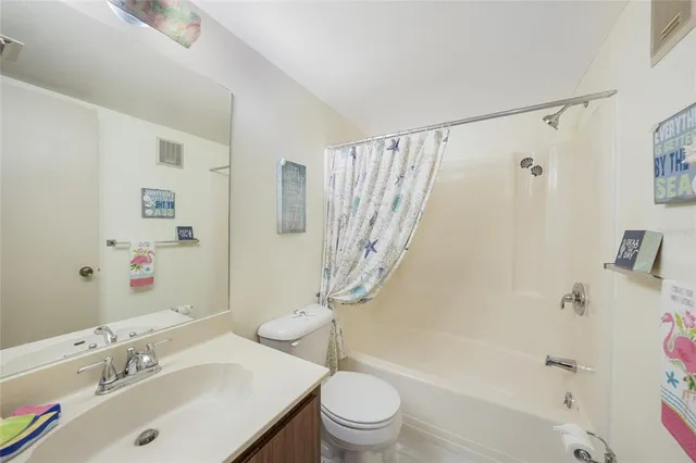 a bathroom with a sink mirror and toilet