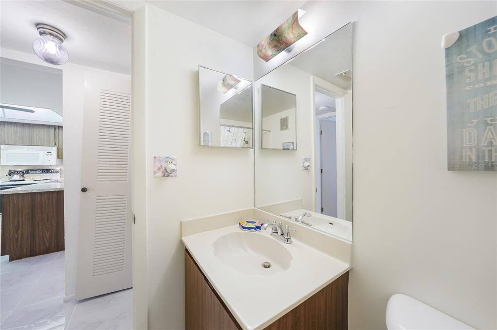 25225 Rampart Boulevard, Unit 1604 Punta Gorda, FL 33983 - Photo 21 of 39 a bathroom with a sink mirror and toilet