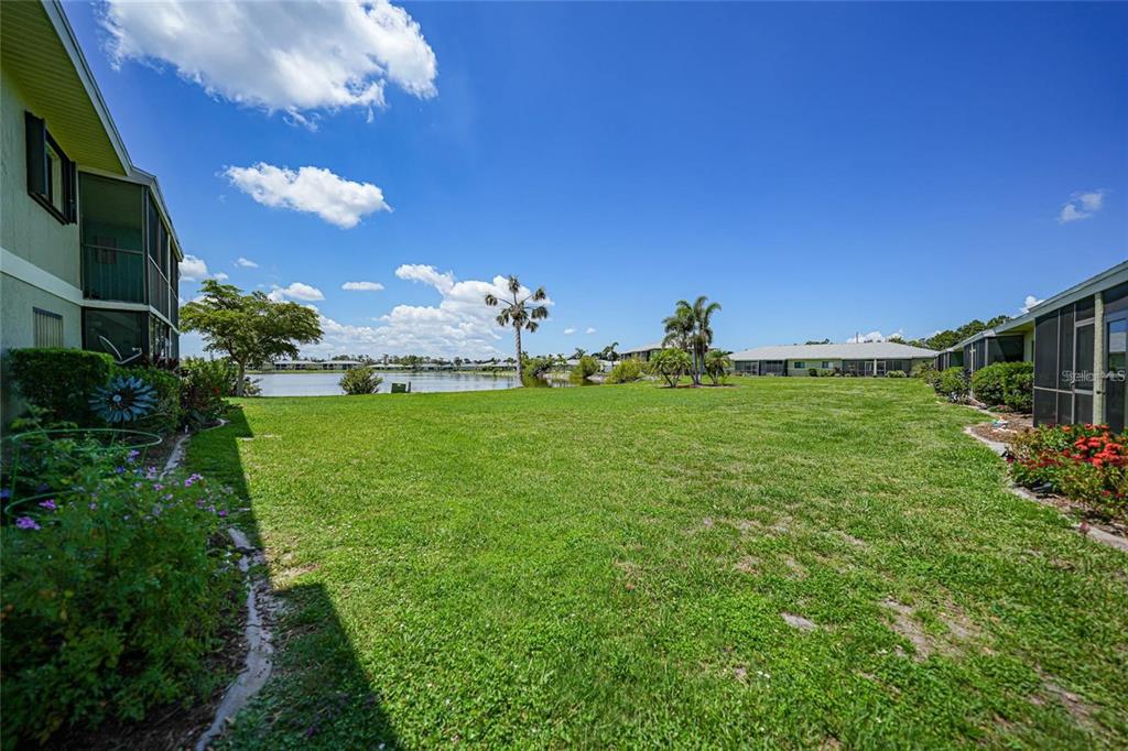 25225 Rampart Boulevard, Unit 1604 Punta Gorda, FL 33983 - Photo 26 of 39 a backyard of a house with lots of green space