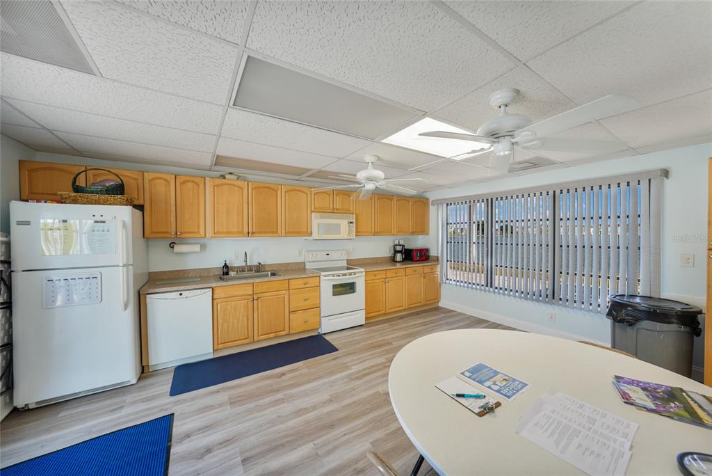 25225 Rampart Boulevard, Unit 1604 Punta Gorda, FL 33983 - Photo 34 of 39 a large kitchen with cabinets a sink and appliances