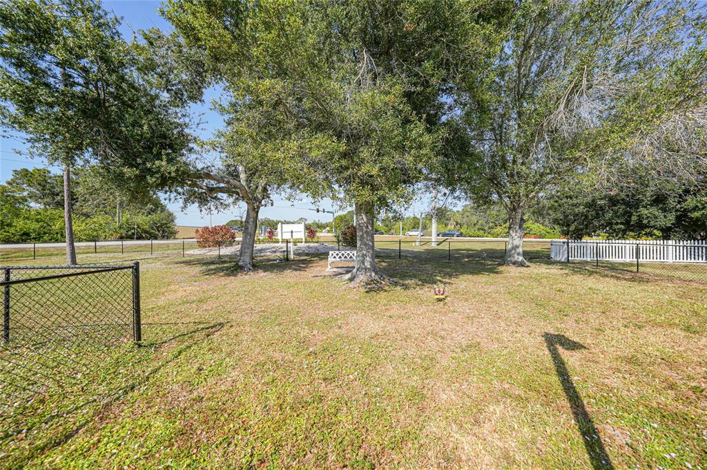 25225 Rampart Boulevard, Unit 1604 Punta Gorda, FL 33983 - Photo 38 of 39 a view of backyard with large trees