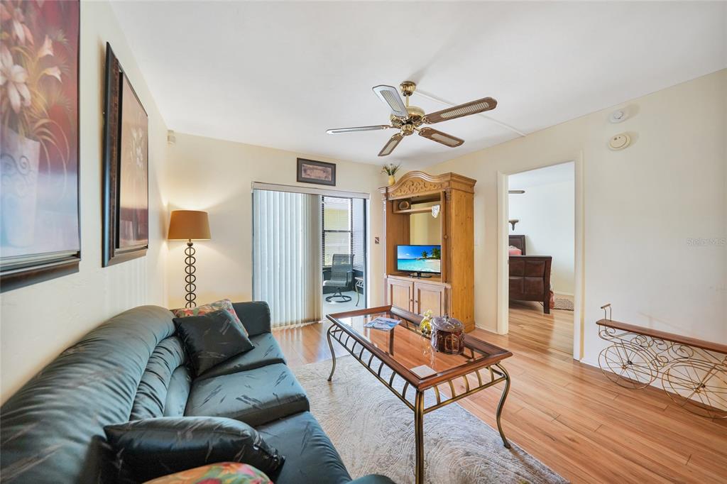 25225 Rampart Boulevard, Unit 1604 Punta Gorda, FL 33983 - Photo 5 of 39 a living room with furniture and a wooden floor