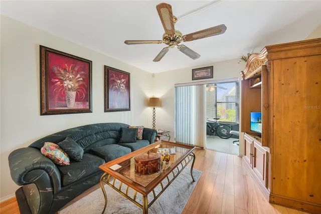 a living room with furniture and a wooden floor