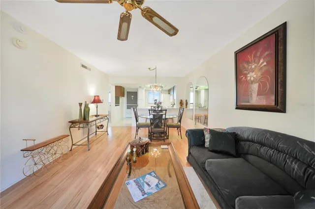 a living room with furniture and kitchen view