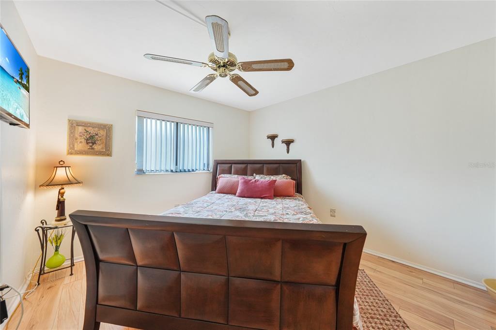 25225 Rampart Boulevard, Unit 1604 Punta Gorda, FL 33983 - Photo 8 of 39 a bedroom with a bed and a chandelier