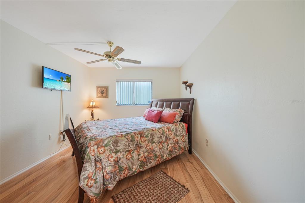 25225 Rampart Boulevard, Unit 1604 Punta Gorda, FL 33983 - Photo 10 of 39 a bedroom with a bed and a chandelier