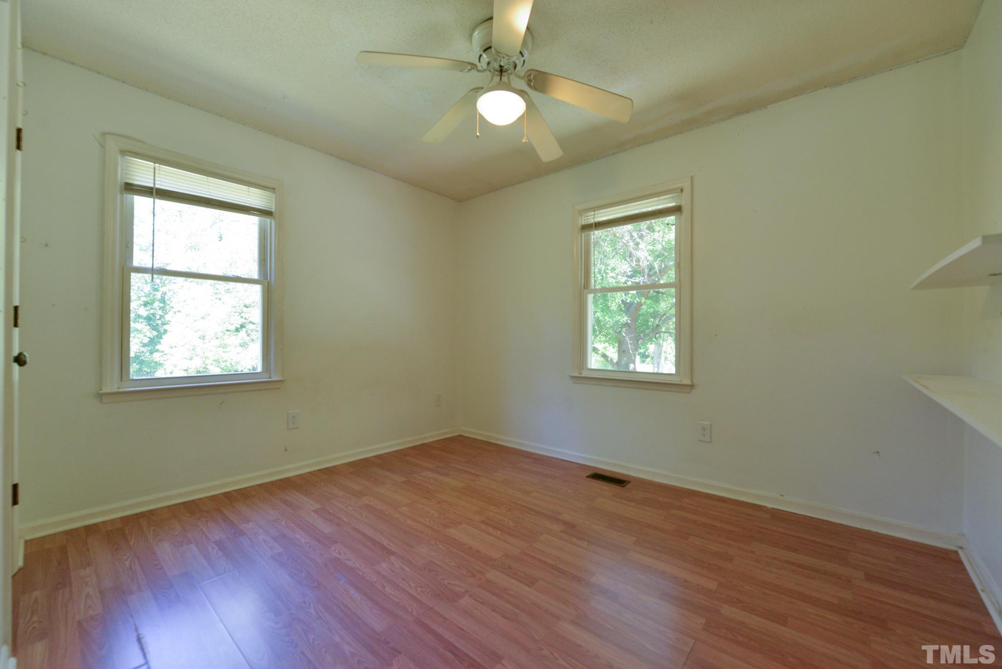119 Mt Pleasant Road Willow Spring, NC 27592 - Photo 17 of 22 a view of empty room with wooden floor and fan