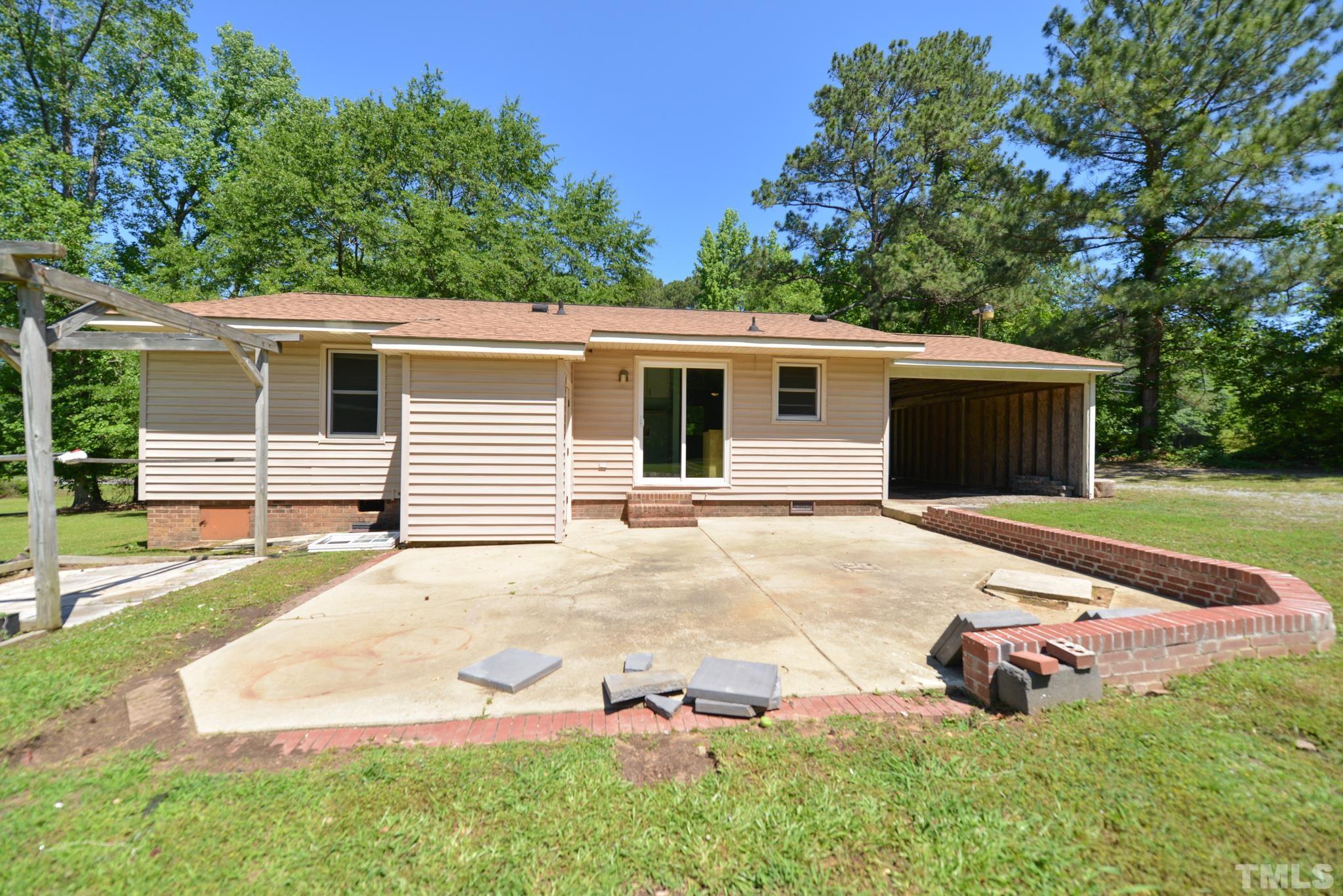 119 Mt Pleasant Road Willow Spring, NC 27592 - Photo 19 of 22 a backyard of a house with yard and garage