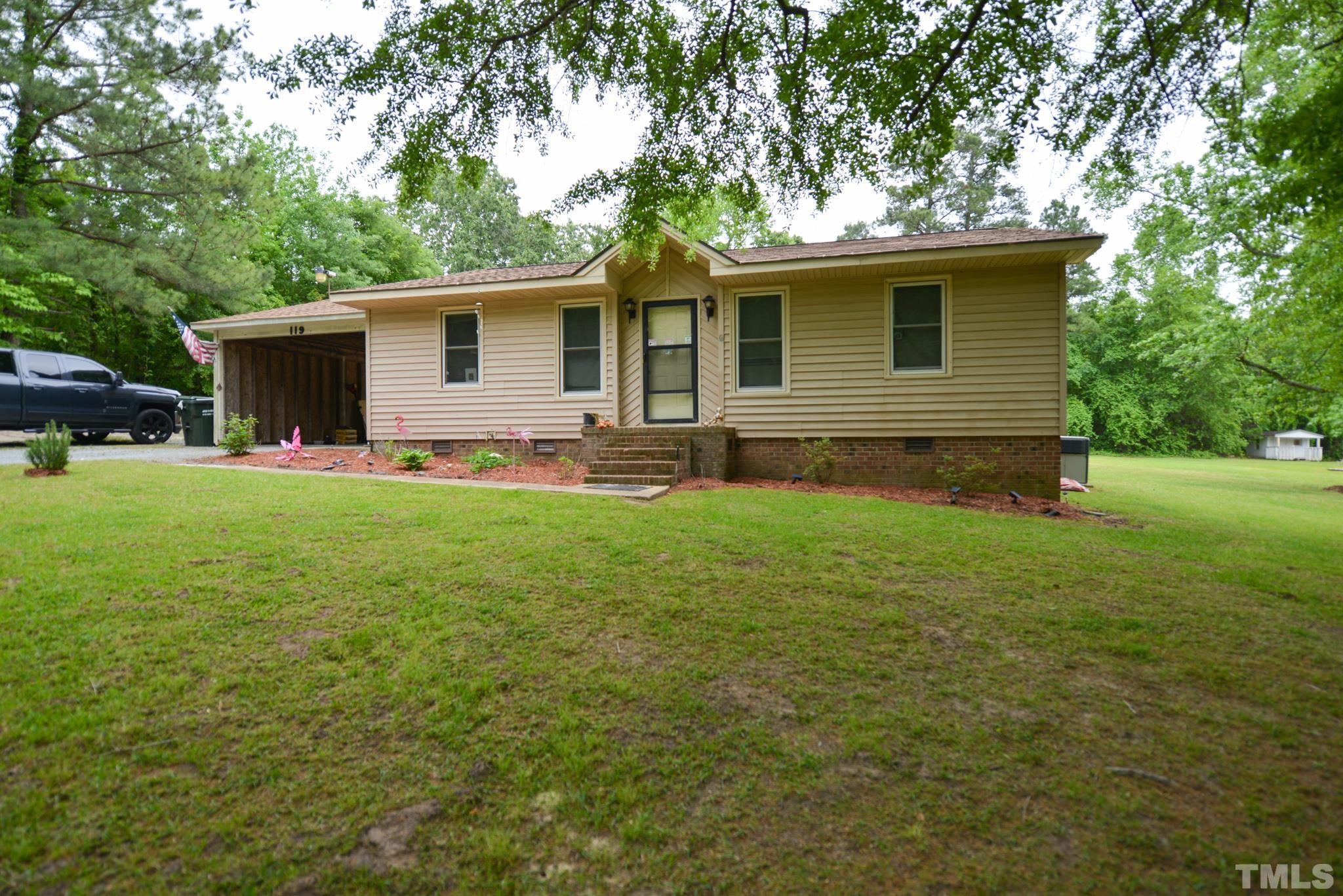 119 Mt Pleasant Road Willow Spring, NC 27592 - Photo 3 of 22 a backyard of a house with yard and barbeque oven