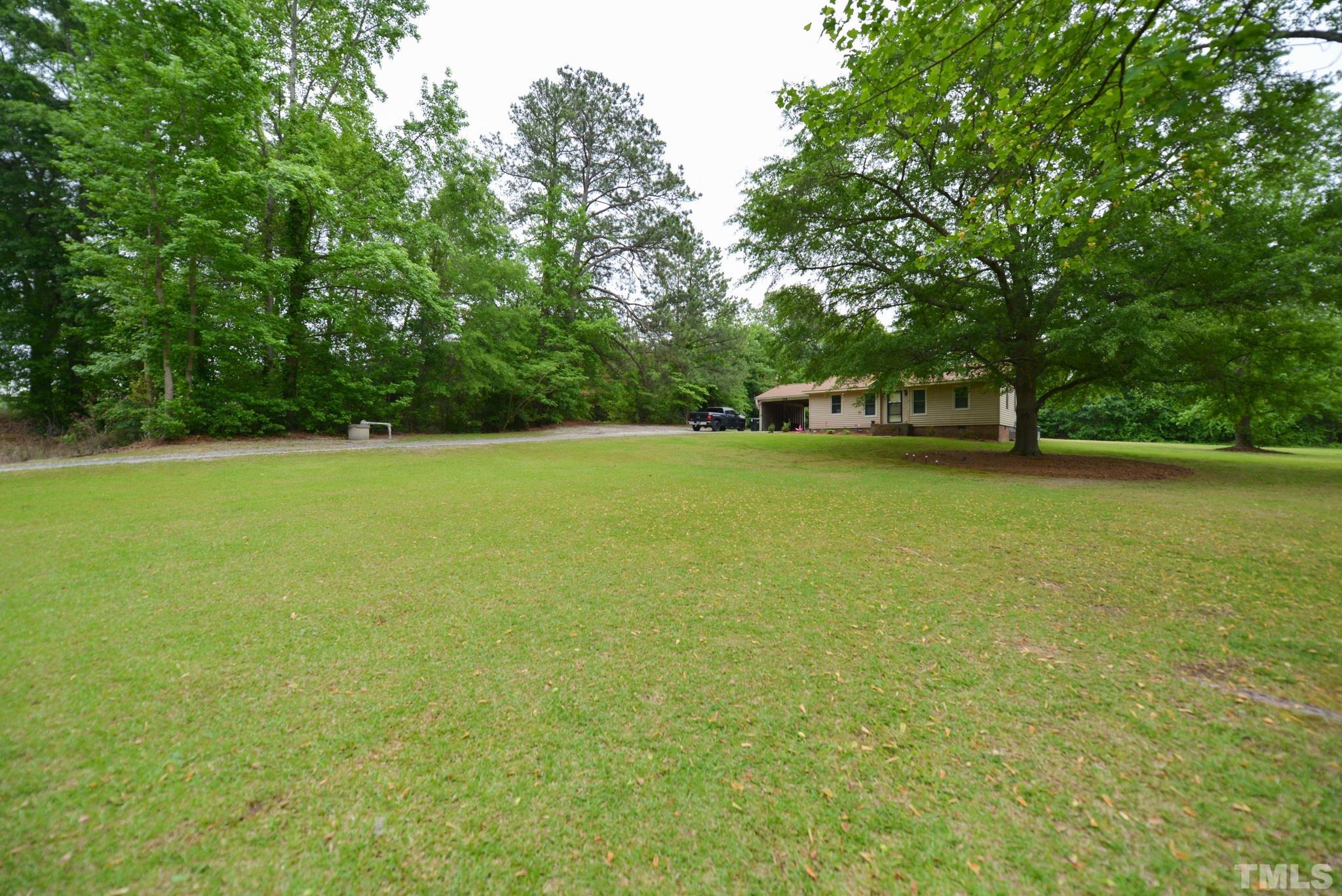 119 Mt Pleasant Road Willow Spring, NC 27592 - Photo 4 of 22 a view of a lake with outdoor space