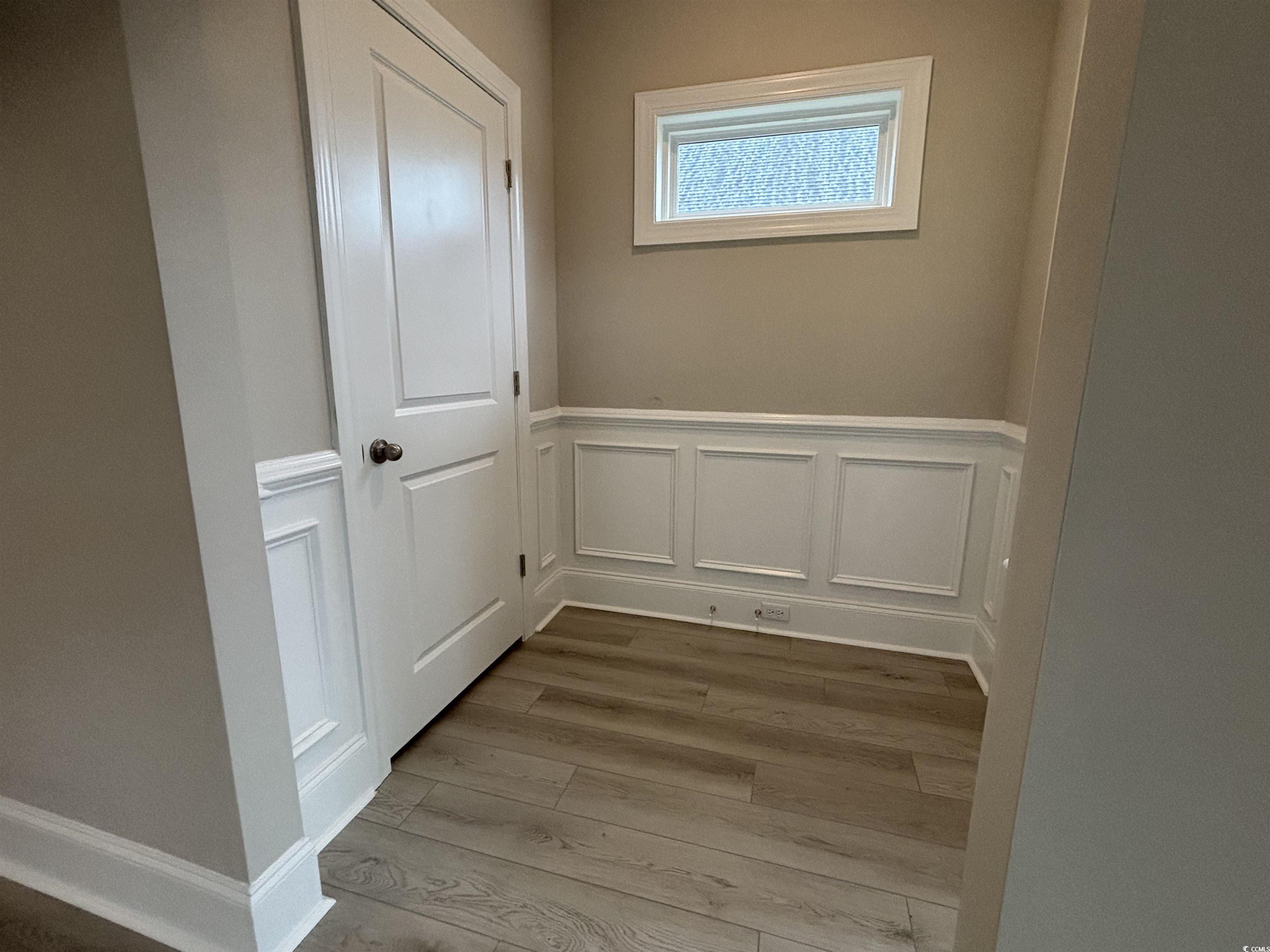 3135 Tiger Tail Road Conway, SC 29526 - Photo 8 of 24 Entryway with wood finished floors, wainscoting, and a decorative wall