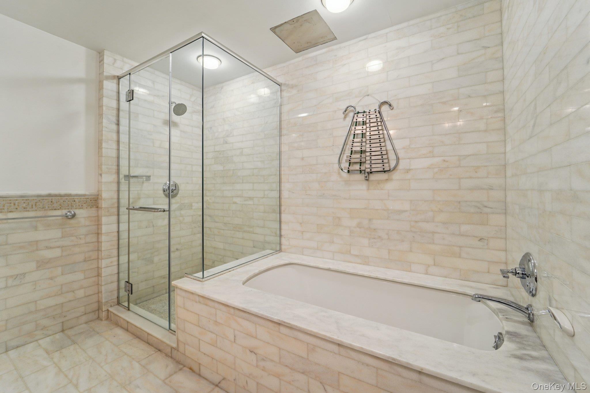 1 Renaissance Square, Unit 25G White Plains, NY 10601 - Photo 12 of 23 a bathroom with a bathtub and a shower