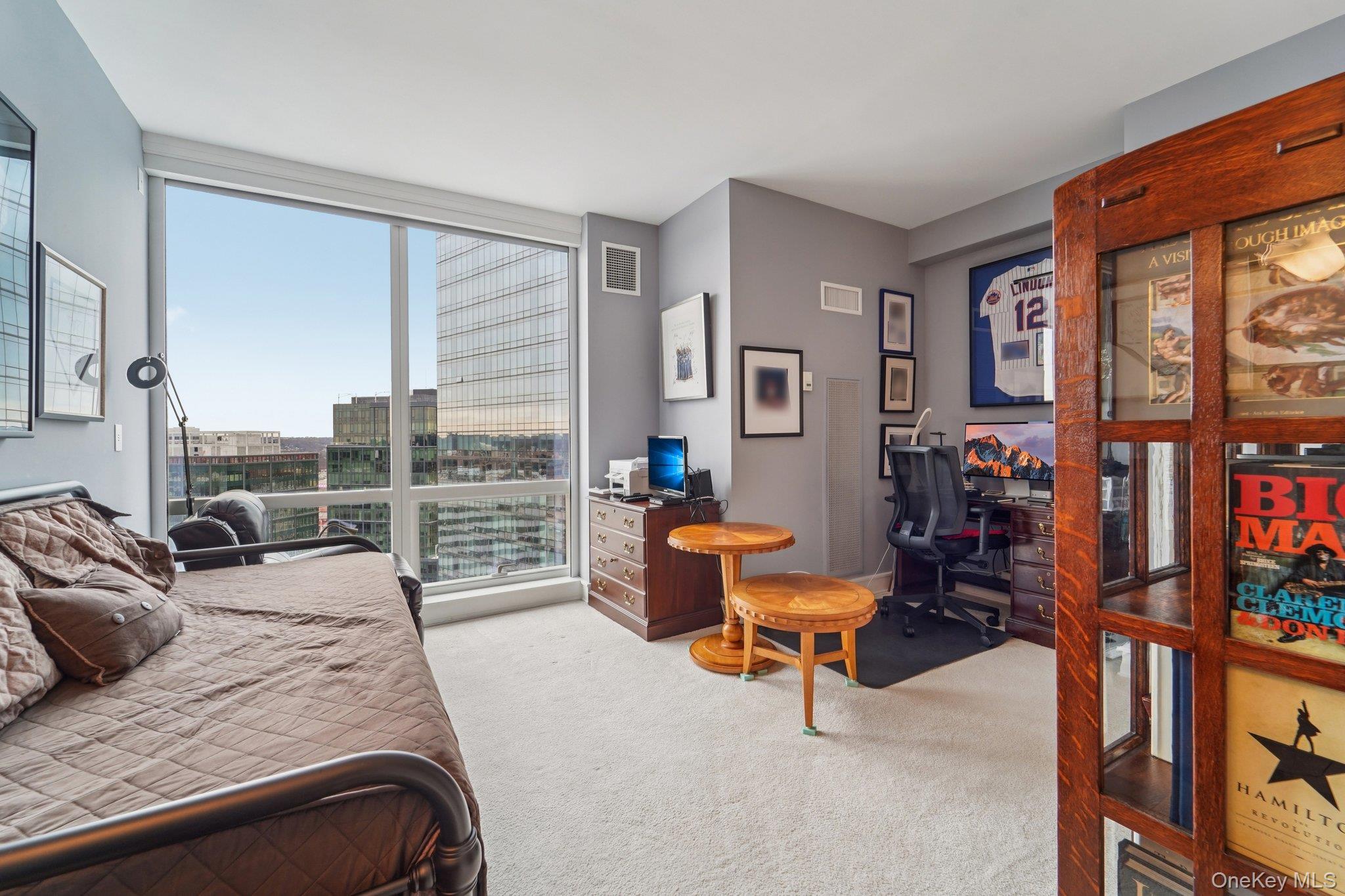 1 Renaissance Square, Unit 25G White Plains, NY 10601 - Photo 16 of 23 a bedroom with furniture and a large window