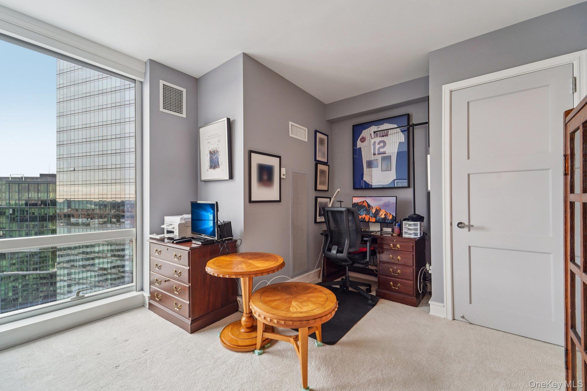 1 Renaissance Square, Unit 25G White Plains, NY 10601 - Photo 17 of 23 a living room with furniture and a large window