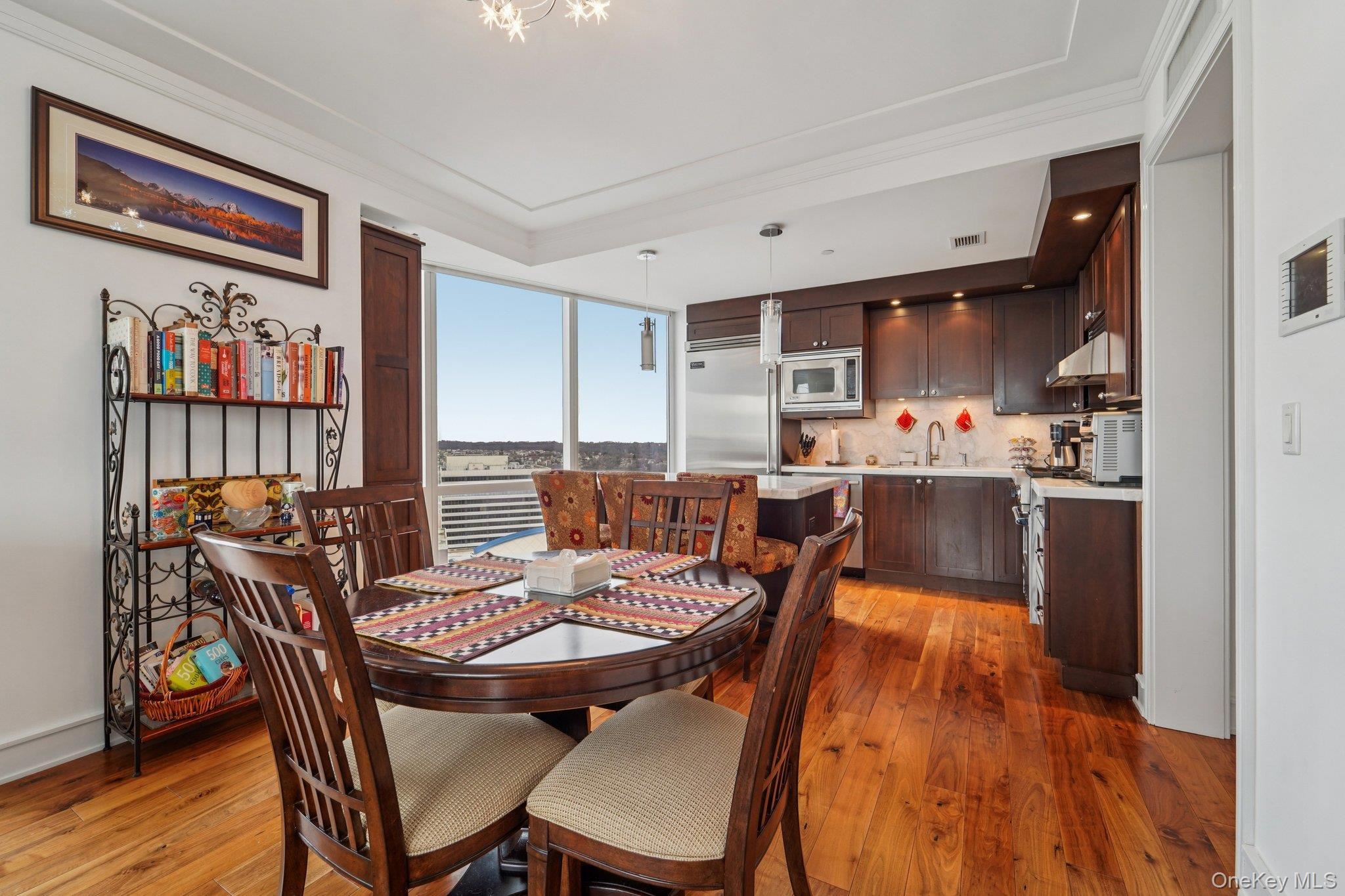 1 Renaissance Square, Unit 25G White Plains, NY 10601 - Photo 4 of 23 a dining room with furniture a rug and wooden floor