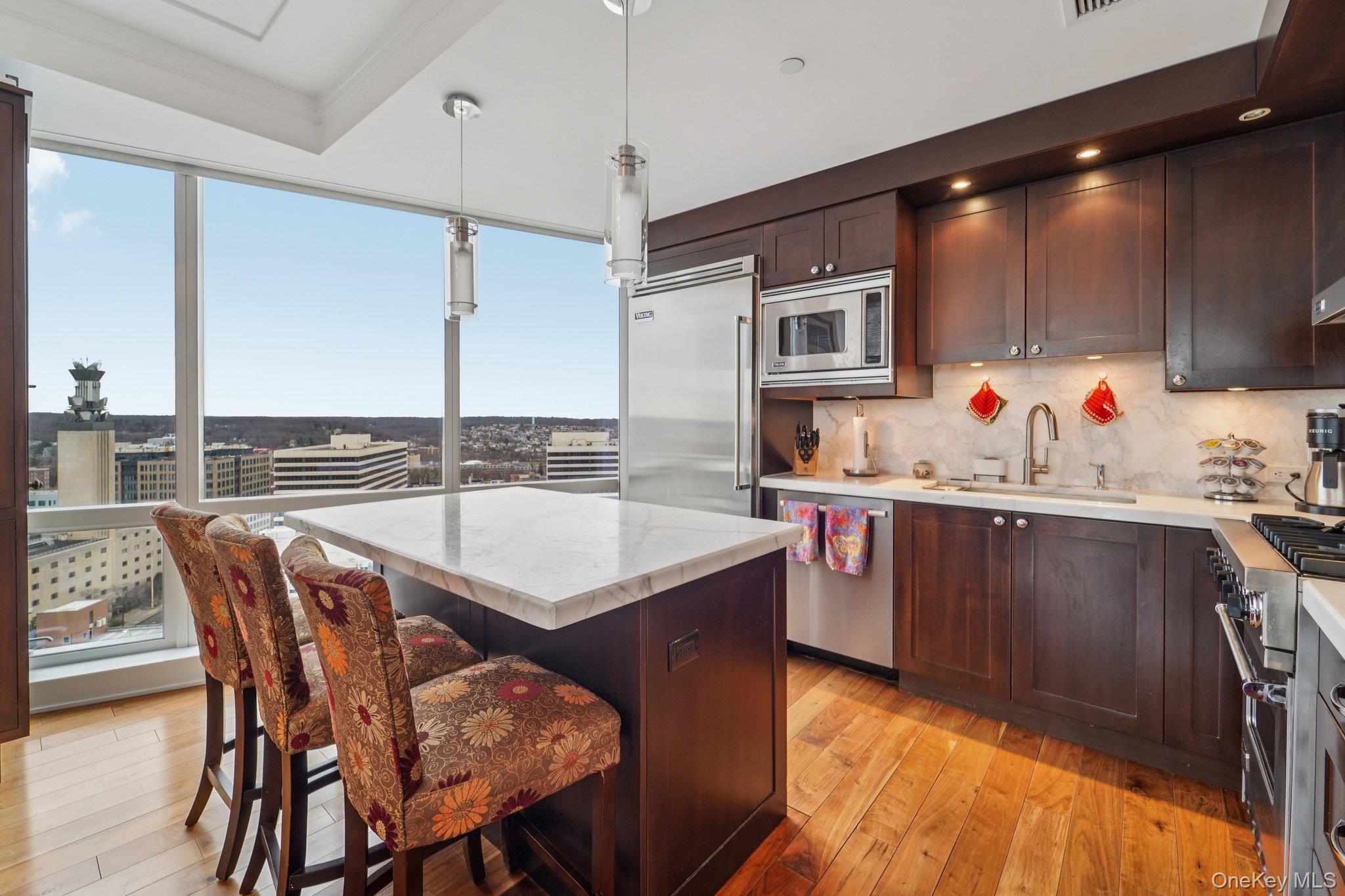 1 Renaissance Square, Unit 25G White Plains, NY 10601 - Photo 5 of 23 a kitchen with a sink stove and microwave