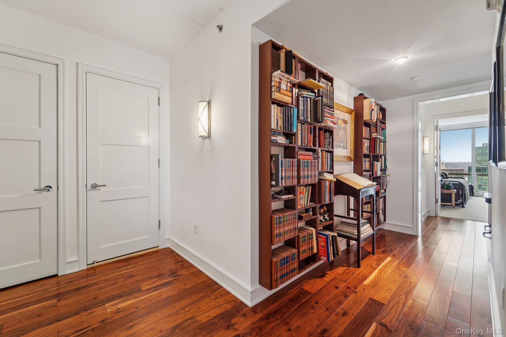 1 Renaissance Square, Unit 25G White Plains, NY 10601 - Photo 6 of 23 a view of a hallway with wooden floor and workspace