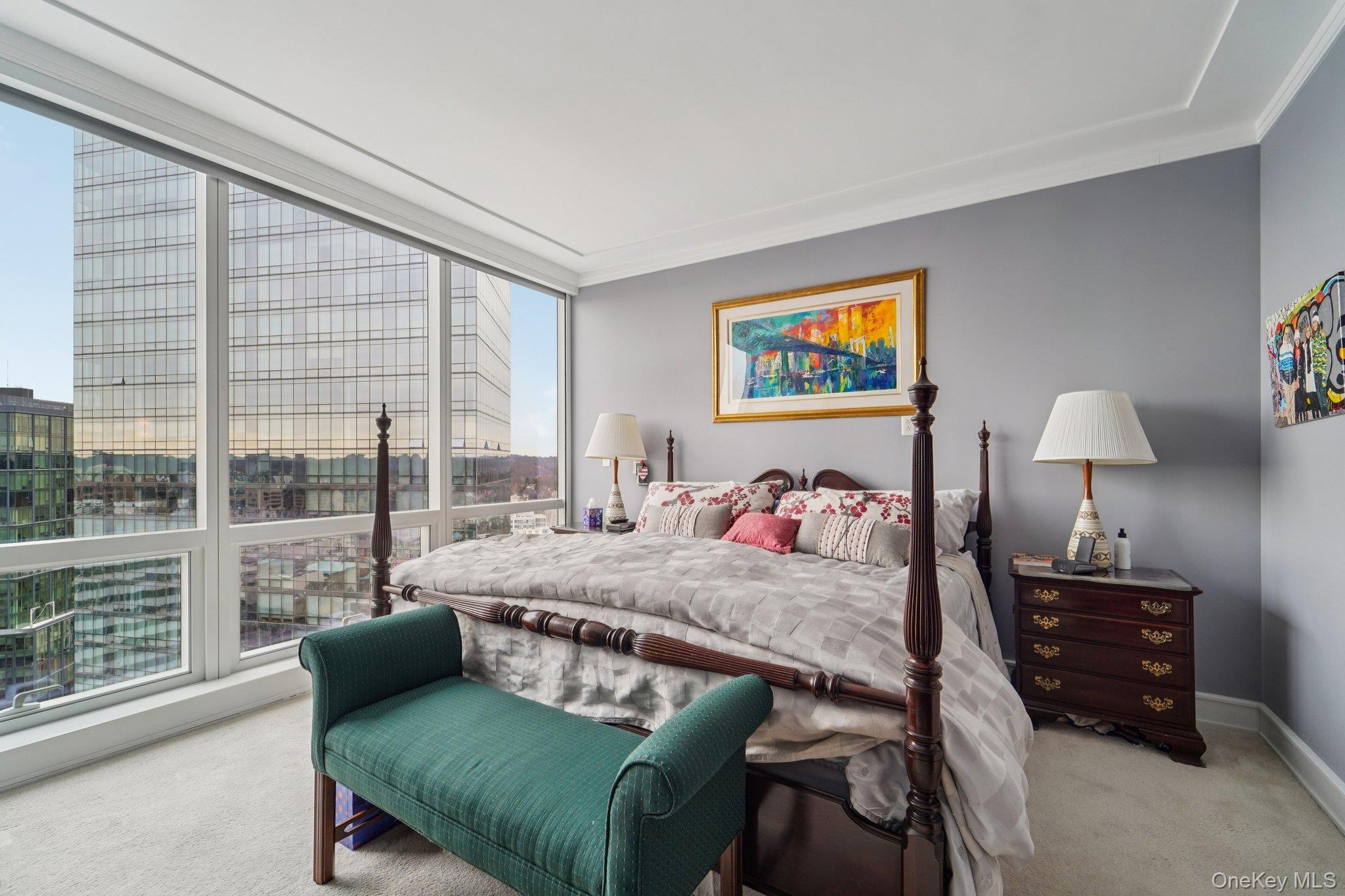 1 Renaissance Square, Unit 25G White Plains, NY 10601 - Photo 10 of 23 a bedroom with a bed window and a lamp
