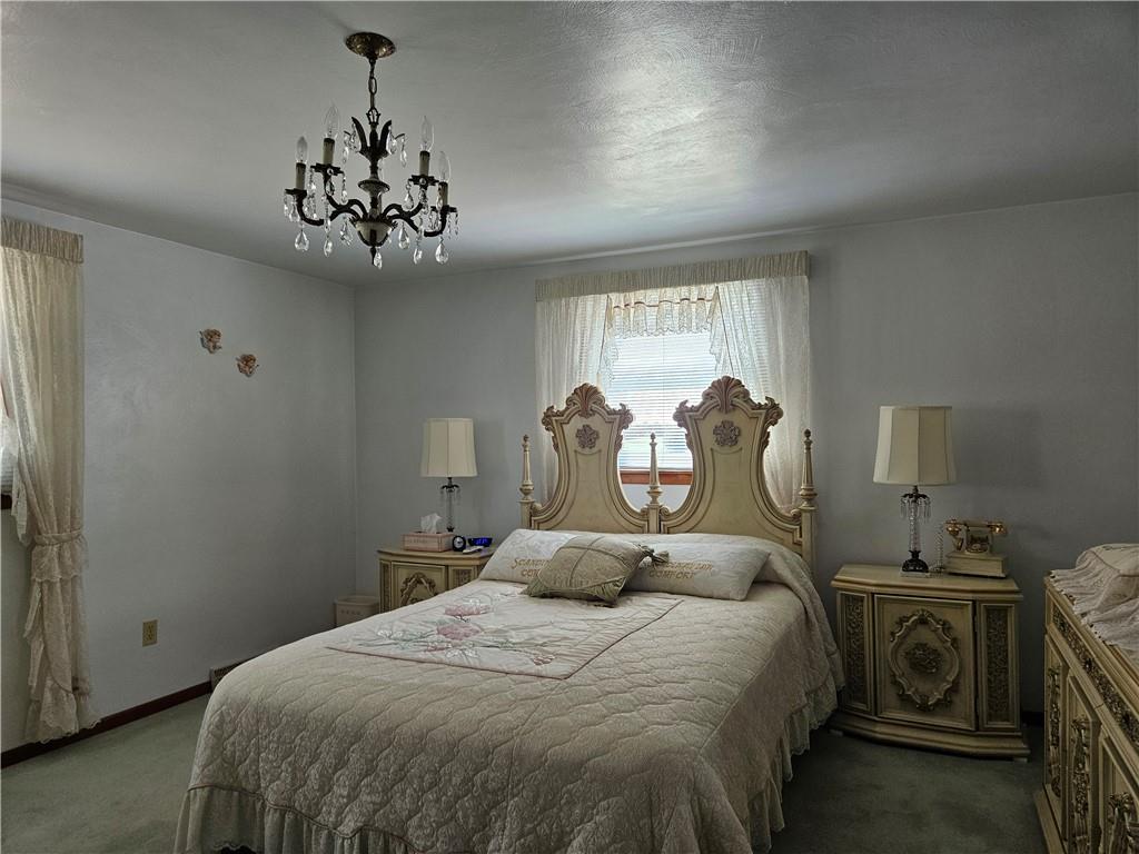 412 Cole Road Sarver, PA 16055 - Photo 22 of 48 a bedroom with a bed and a chandelier